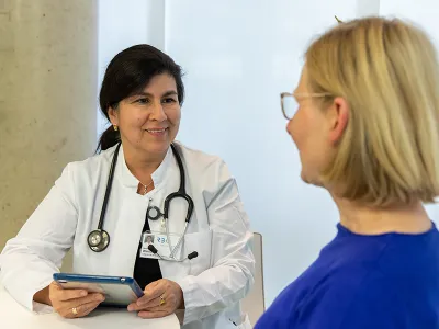 Dr. Winkler sitzt einer Patientin gegenüber.