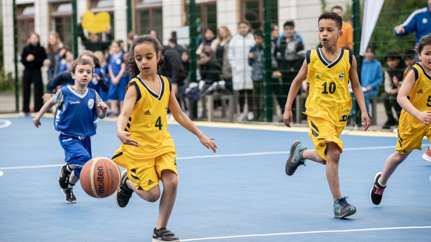 Girls and boys play basketball